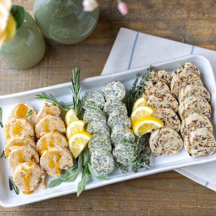 Four varieties of compound butters served on a tray.